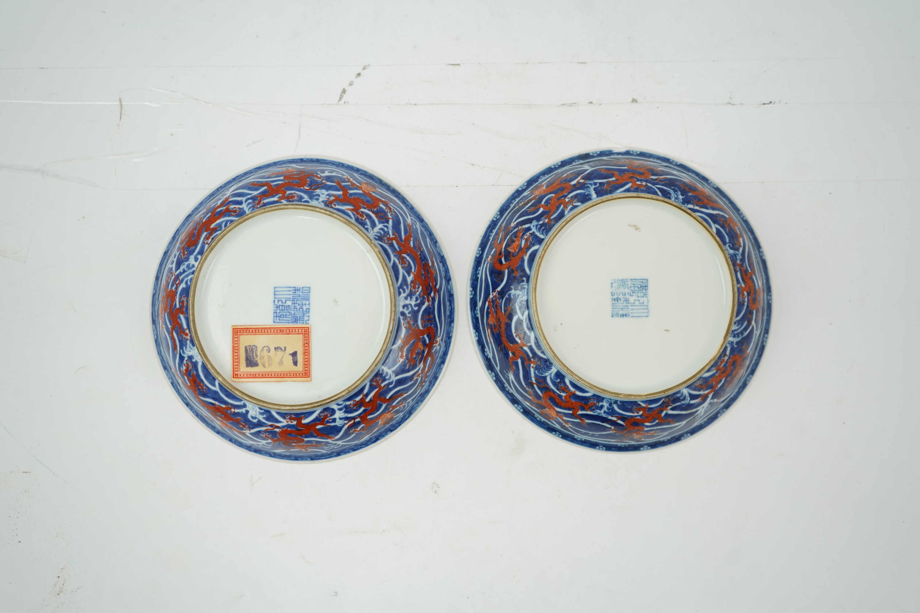 A pair of Chinese iron red and underglaze blue ‘dragon’ dishes, Qianlong seal mark and of the period (1736-95)